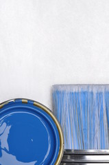 Fototapeta na wymiar Top view of blue paint can with brush on grey metal background