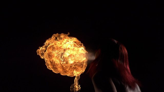 Fire performer blowing fire shooting with high speed camera, phantom flex.