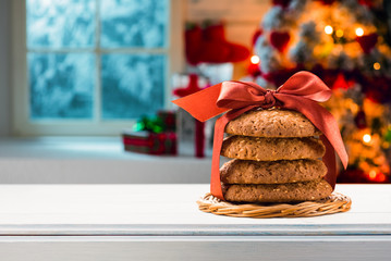 Christmas cookies packed red ribbon on a wooden table