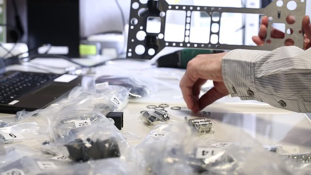 conveyor worker assembling electronic device on factory
