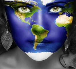 Map of the world on face of girl with green eyes