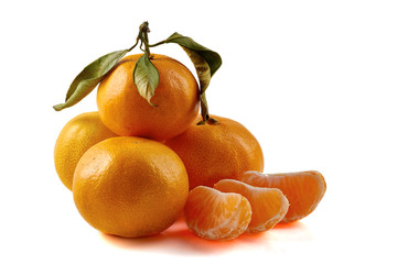 Group of tangerines with lslices and leaves isolated on white background