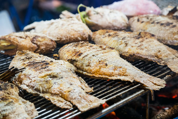 Fried fish is sold at the Asian street  market