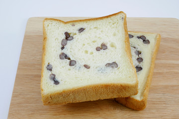 The sliced red bean bread on chopping board. (1)