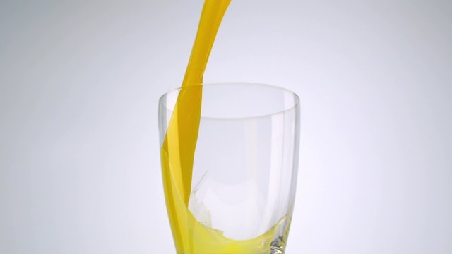 Pouring orange juice into glass shooting with high speed camera, phantom flex.