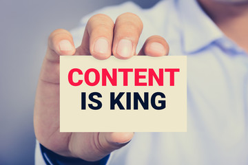 CONTENT IS KING message on the card shown by a man