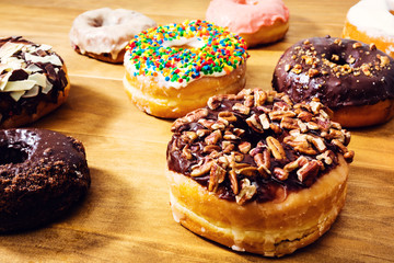 Assorted donuts on wooden background
