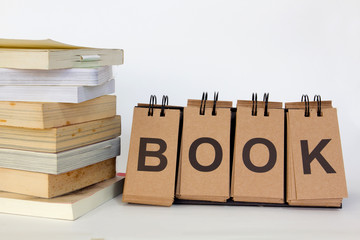 book stack with text "Book" on white background