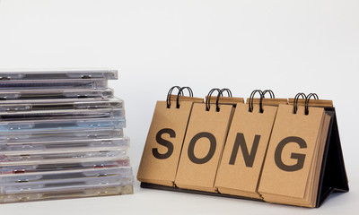 CD Stack and letters text Song on white background