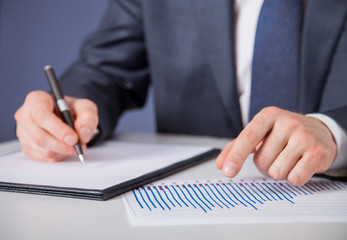 Businessman signing a document