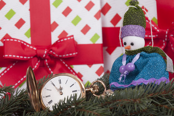 Christmas card, fir branches, snowman and gold watch
