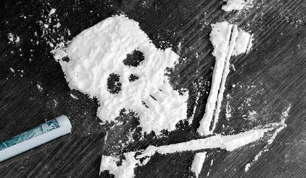 Drug powder cocaine in the silhouette of the skull
