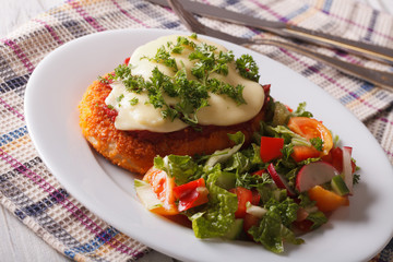 Italian food: Chicken Parmigiana and salad close up. Horizontal
