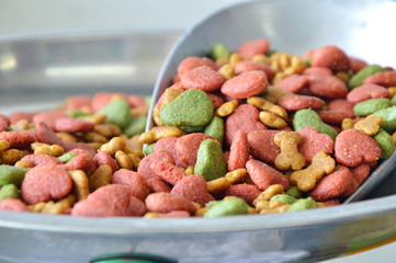 dog food in iron scoop on weighing scale
