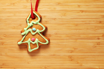 Image of gingerbread Christmas tree cookie over wooden texture