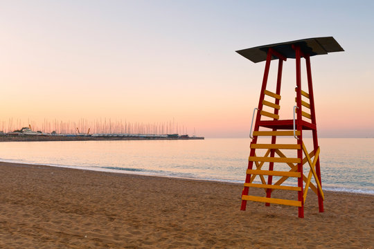 Lifeguard tower on a beach in Palaio Faliro and dry dock of Alimos marina in Athens, Greece.