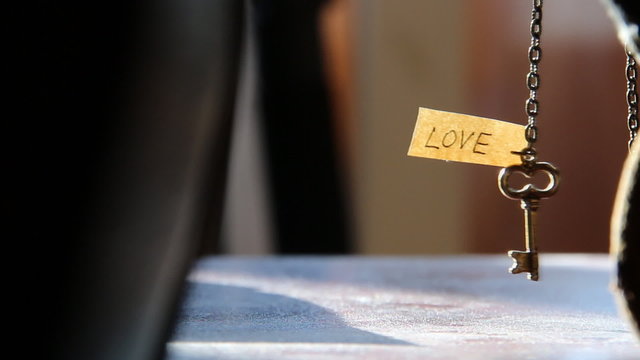 Key and text "Love". Golden key to LOVE idea.
