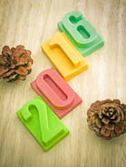 Happy new year 2016, bar of chocolate number on wooden background, Color effect 	