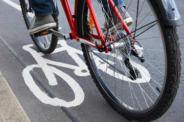 Close Up Of Man Riding Bike In Cycle Lane