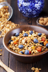 Healthy breakfast. Fresh granola, muesli with berries, honey and milk 