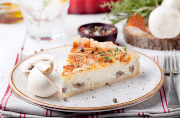Mushroom, champignon pie, quiche slice on a ceramic plate