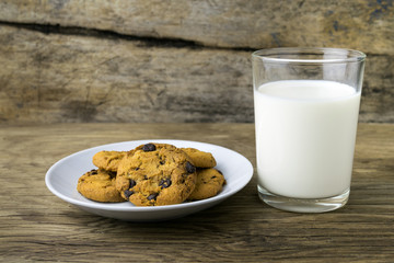 cookies and a glass with milk with a white note for santa