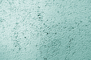Light green colored wall surface; mortar texture; can be used as background.