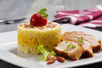 Portion of risotto with roasted chicken.