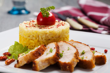 Portion of risotto with roasted chicken.