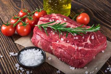 Raw marbled meat steak Ribeye on dark wooden background