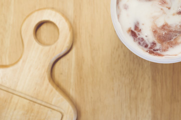 chopping board and fruit yogurt jar close view