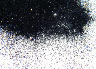 Black glitter sparkle on white background with space for text