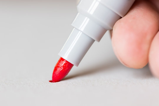 Red Marker Draws A Line Close Up Photo