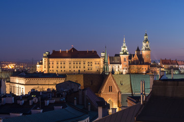 Fototapeta na wymiar Royal castle and cathedral on the Wawel hill seen from the Town Hall tower in Krakow, Poland in the evening