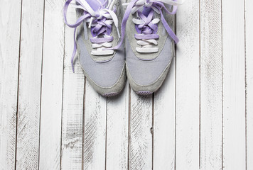 Pair of sport shoes on white wooden background