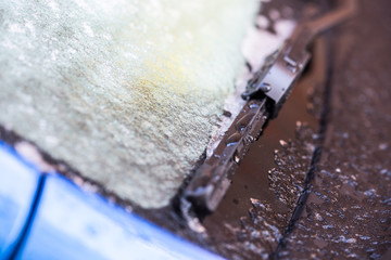 Closeup of a car covered in snow and ice