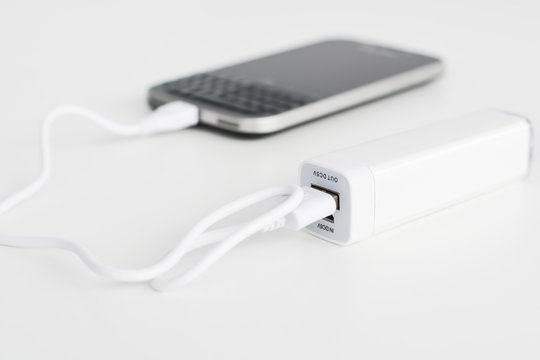 Mobile phone portable battery recharging a smartphone
