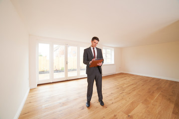 Estate Agent Looking At Vacant Property