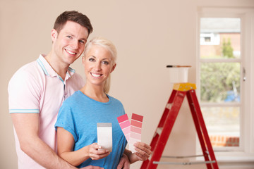 Couple Looking At Paint Swatches Together