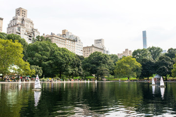 Fototapeta na wymiar model boats sailing on Conservatory Water in central park in manhattan, new york city
