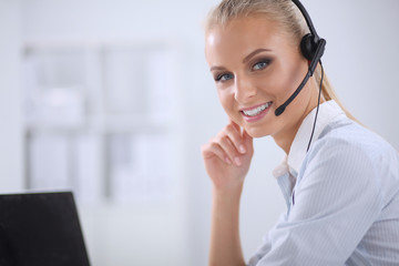 Portrait of beautiful businesswoman working at her desk with he