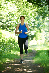 Middle Aged Woman Running In Countryside