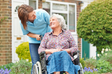 Carer With Senior Woman In Wheelchair - obrazy, fototapety, plakaty