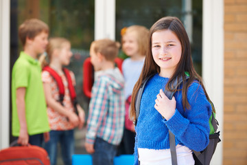 Girl Standing Outside School With Rucksack