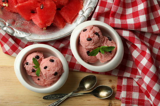 Watermelon ice cream in bowls  on color wooden background
