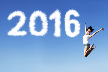 Excited woman jumping on the air with numbers 2016