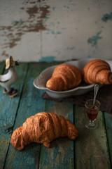 Fragrant croissants lie on a wooden table