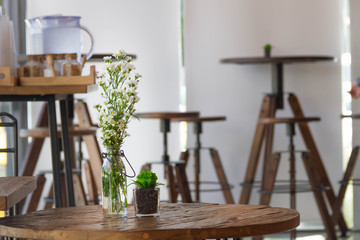 Flowers in a glass vase on a wooden table.