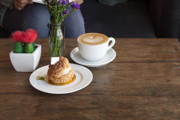 Eclair coffee cream in a dish on a wooden floor.