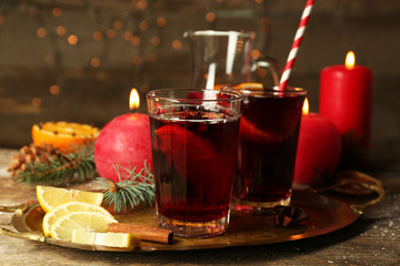 Decorated composition of mulled wine in glasses on wooden table